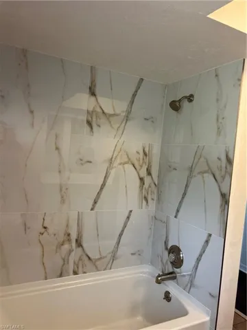 Full bathroom with bathing tub / shower combination