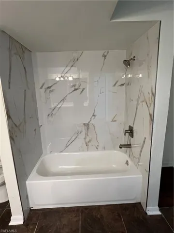 Full Master bath featuring tub / shower combination