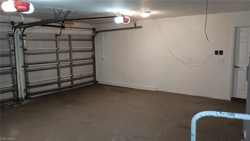 Garage featuring a garage door opener