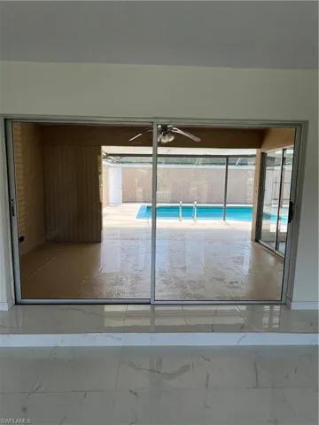 View of swimming pool with ceiling fan