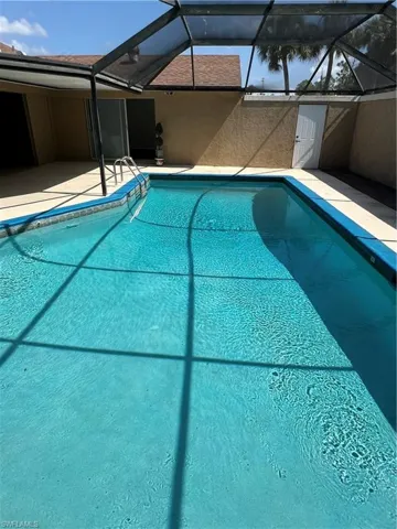 Outdoor pool with a patio and a lanai