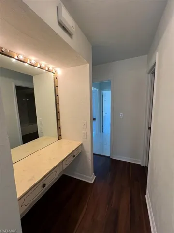 Master Bathroom featuring wood finished floors and baseboards