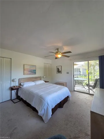Bedroom with access to exterior, carpet, and ceiling fan