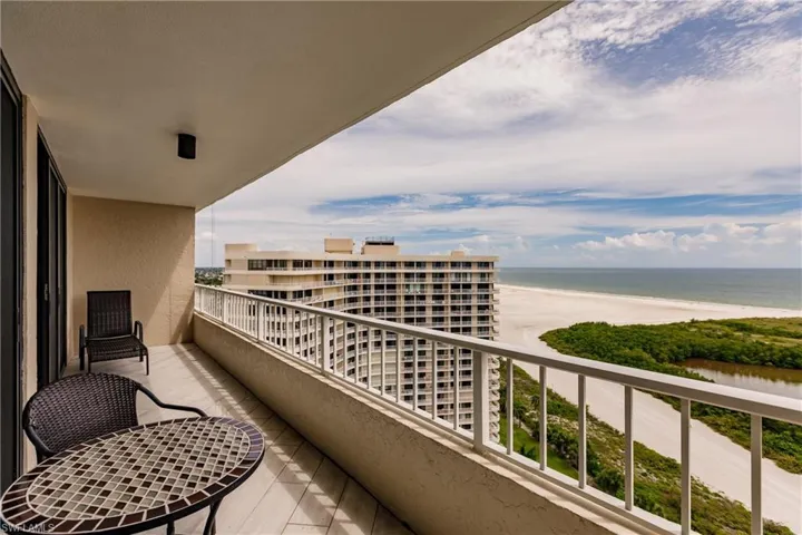 Balcony featuring view of water and beach