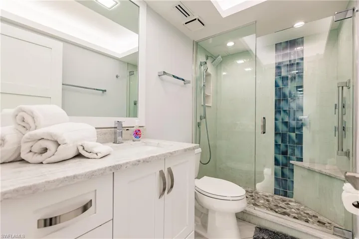 Full bath with vanity and a stall shower