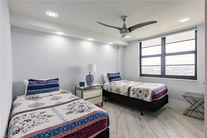 Bedroom featuring wood tiled floors and ceiling fan