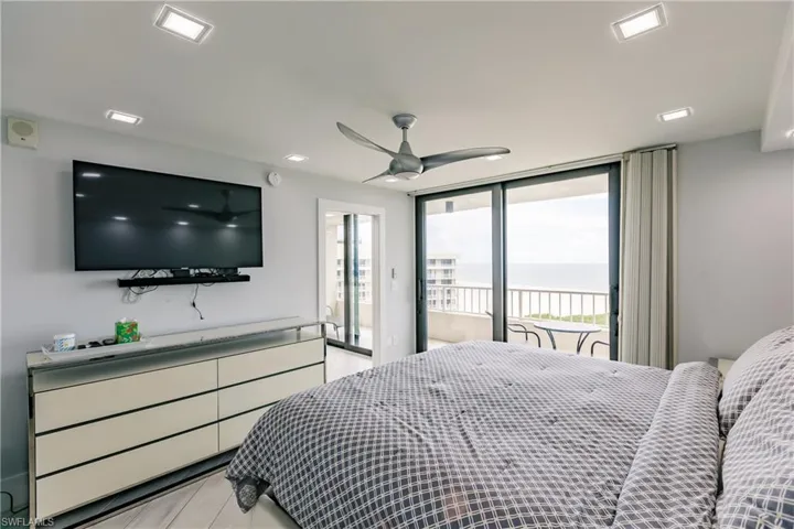 Bedroom with access to outside, ceiling fan, and light wood-type flooring