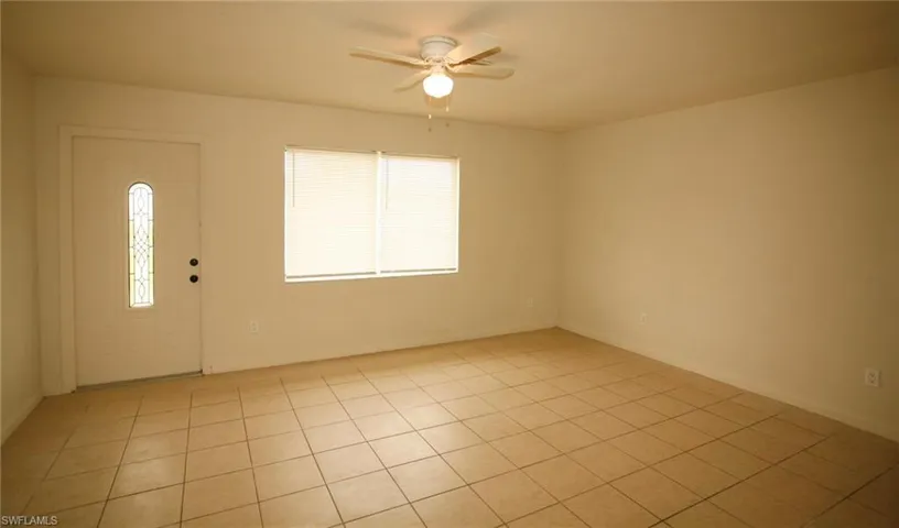 Empty room with a ceiling fan and baseboards