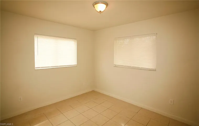Unfurnished room featuring baseboards and light tile patterned floors
