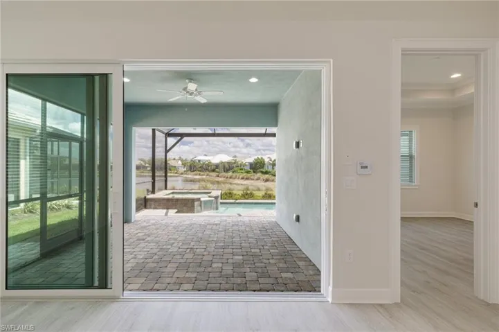 Doorway to outside with recessed lighting, plenty of natural light, ceiling fan, and wood finished floors