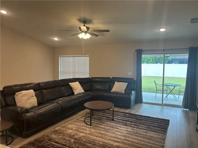 Living room featuring wood finished floors, recessed lighting, and a ceiling fan