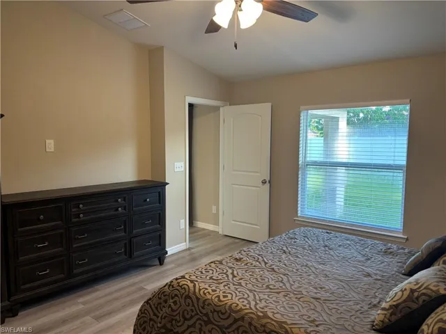 Bedroom with light wood-style floors and a ceiling fan