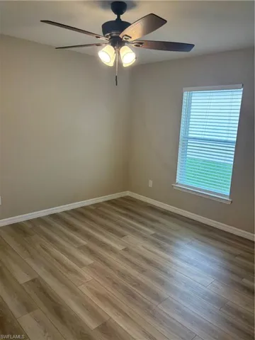 Spare room with light wood-style flooring and a ceiling fan
