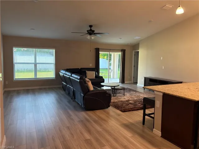 Living room featuring light wood-style flooring and a ceiling fan