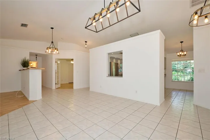 Unfurnished room featuring lofted ceiling and light tile patterned flooring