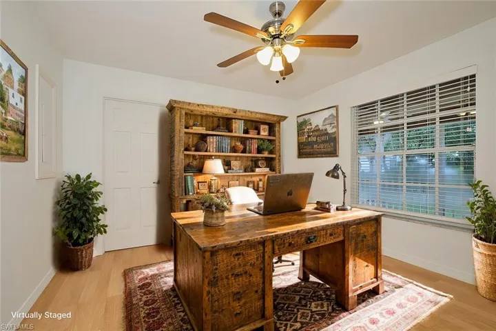 Office with ceiling fan and light hardwood / wood-style flooring