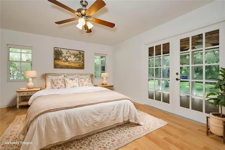 Bedroom featuring wood-type flooring and ceiling fan