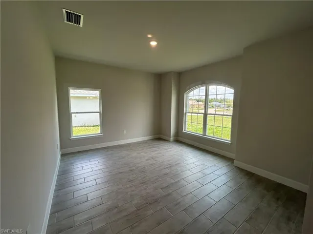Formal Living Room/Den with Wood Look Ceramic Tiled Floors and Recessed Lighting