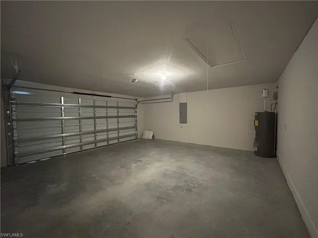 Garage featuring Water Heater and Electric Panel