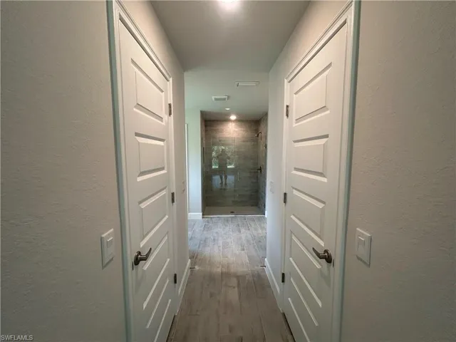 Hall featuring Dual Walk In Closets
