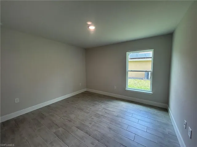 4th Bedroom with Recessed Lighting and Wood Look Tiled Floor