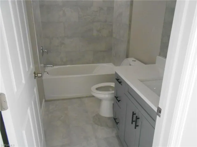 Full bath featuring vanity and shower / tub combination