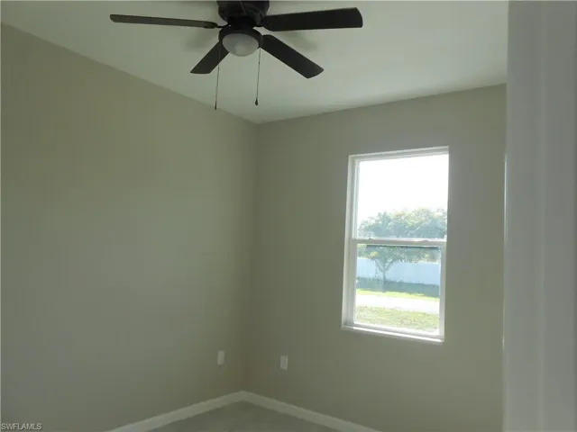 Spare room with baseboards and ceiling fan