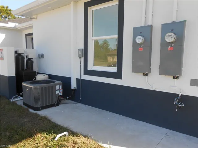 View of property exterior with stucco siding and a patio