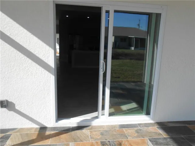 Property entrance featuring stucco siding