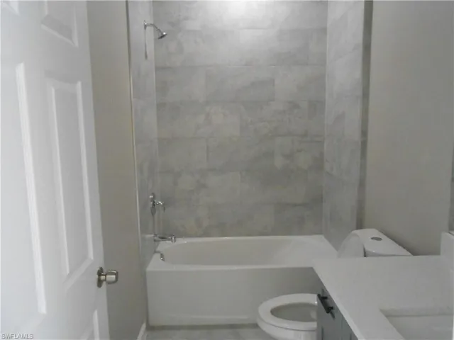 Full bathroom with vanity and bathing tub / shower combination