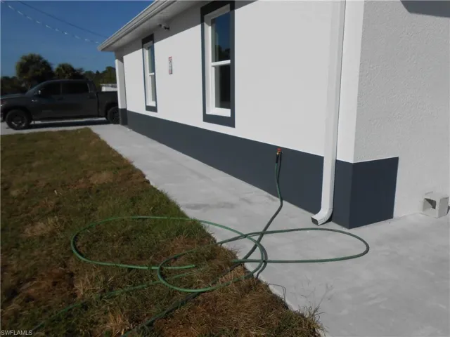 View of home's exterior featuring stucco siding and a yard