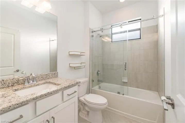 Full bathroom with vanity and combined bath / shower with glass door