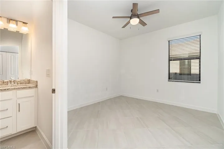 Spare room with baseboards and a ceiling fan
