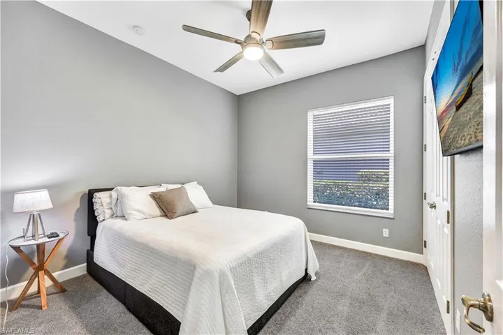 Carpeted bedroom with ceiling fan