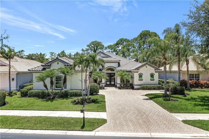 Mediterranean / spanish-style home with a front yard