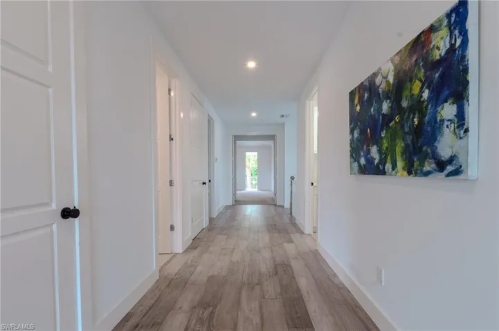 Wonderfully wide hallways bring it altogether- that closed door is the LAUNDRY ROOM w/sink