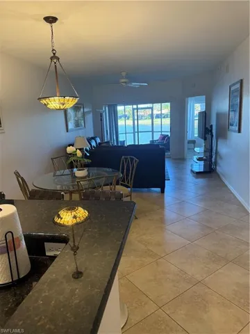 Dining area featuring a ceiling fan and light tile patterned flooring