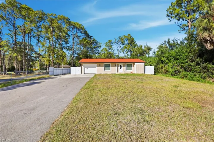 Single story home featuring asphalt driveway and an attached garage