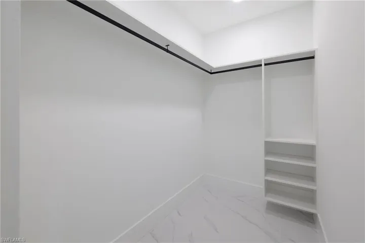 Spacious closet featuring tile patterned floors