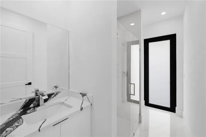 Bathroom with a shower with door and vanity