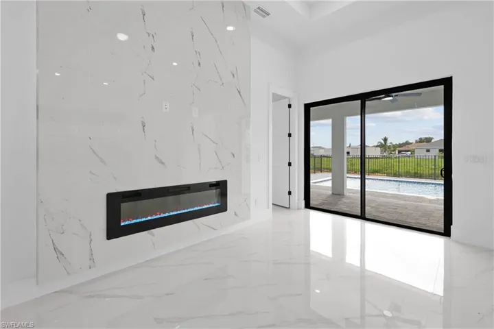 Unfurnished living room with light tile patterned floors and a premium fireplace