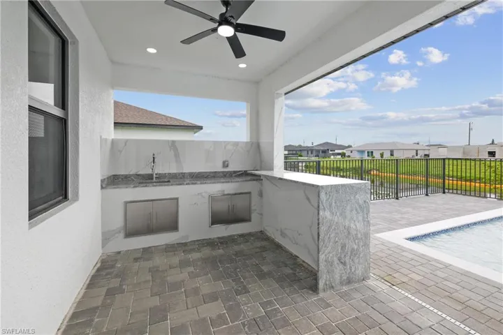 View of patio / terrace featuring sink and ceiling fan