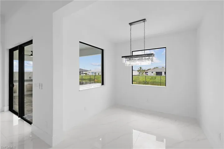 Unfurnished dining area featuring light tile patterned flooring and an inviting chandelier