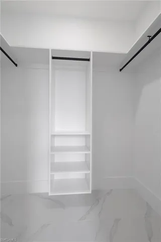 Spacious closet featuring tile patterned flooring