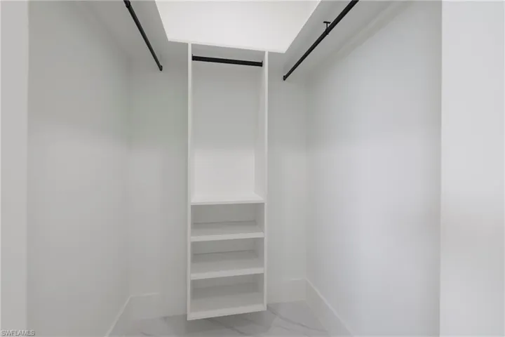 Walk in closet with tile patterned floors
