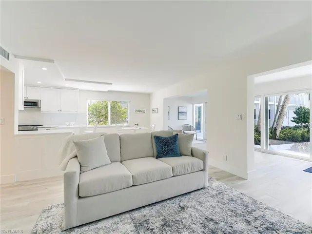 Living area with light wood-style floors and recessed lighting