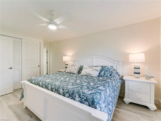 Bedroom featuring light wood-type flooring, a closet, and ceiling fan