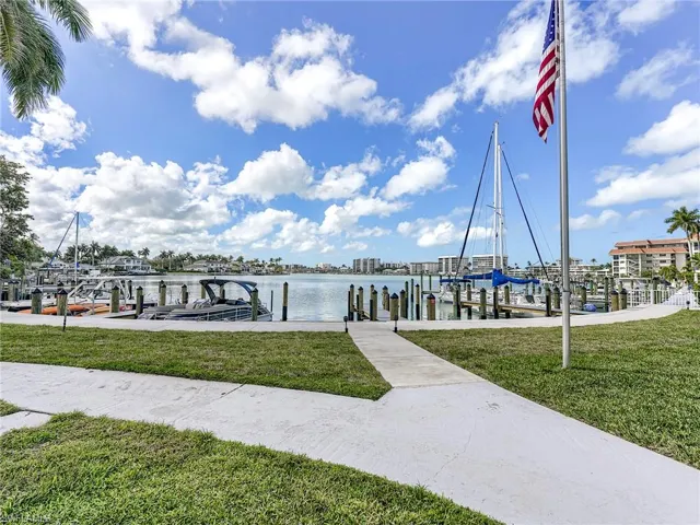 Dock area with a lawn, a water view, and boat lift