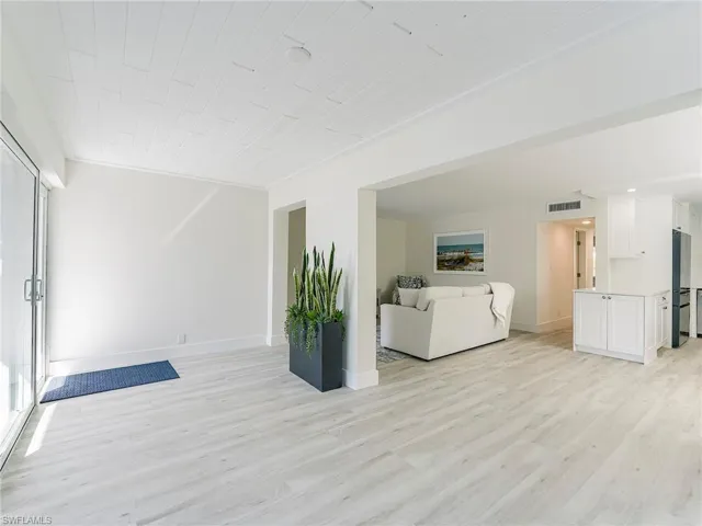 Living room featuring light wood-type flooring and baseboards