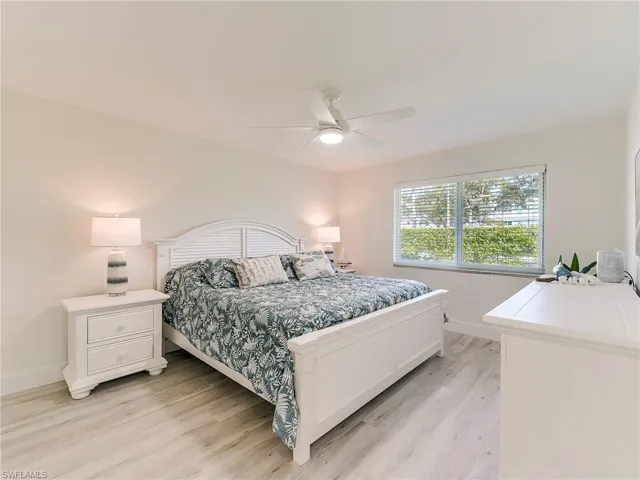 Bedroom with light wood finished floors and a ceiling fan